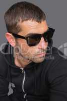 Criminal with sunglasses looking at camera