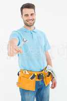 Smiling construciton worker holding wrench