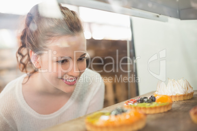 Pretty brunette looking at tarts