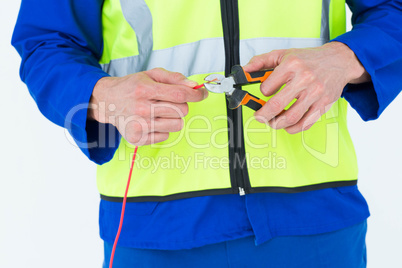 Electrician cutting wire with pliers