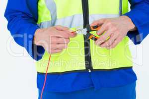 Electrician cutting wire with pliers