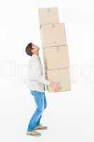 Courier man balancing cardboard boxes
