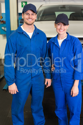 Team of mechanics smiling at camera