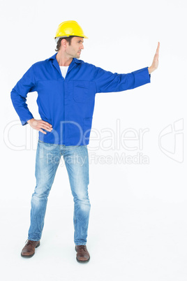 Confident architect pushing over white background