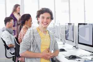 Student smiling at camera in computer class