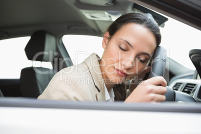 Businesswoman sleeping on the wheel