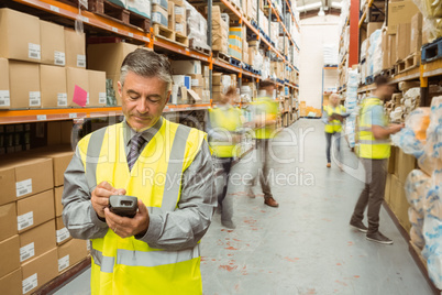 Smiling male manager using handheld