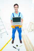 Portrait of repairman holding laptop