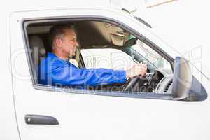 Serious delivery man driving his van