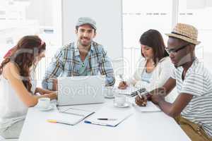 Colleagues taking notes and using laptop