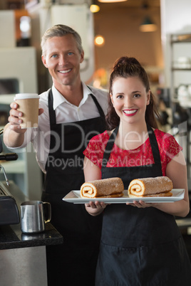 Waitress smiling at the camera showing cakes