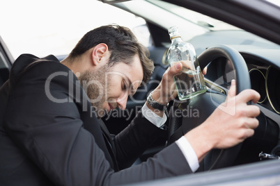 Young businessman driving while drunk