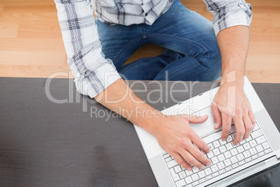 A man sitting on the floor at home