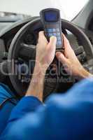 Mechanic using diagnostic tool in the car