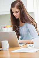 Pretty young girl using laptop