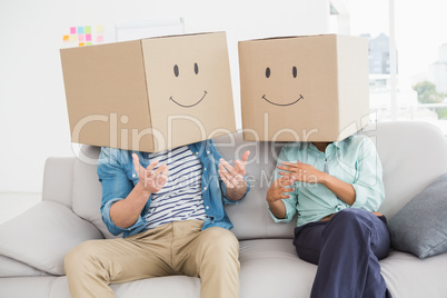 Colleagues covering their head with fun cardboard box
