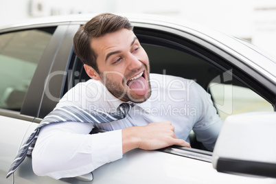 Carefree businessman sitting in drivers seat Carefree businessman sitting in drivers seat