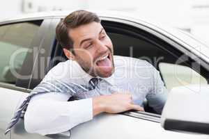 Carefree businessman sitting in drivers seat