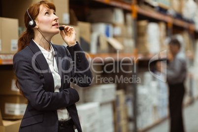 Elegant manager talking into a headset