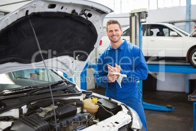 Smiling mechanic looking at camera