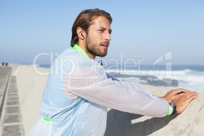 Fit man warming up on promenade