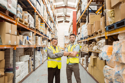 Warehouse team standing with arms crossed