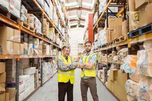 Warehouse team standing with arms crossed