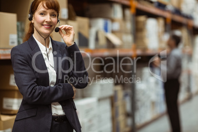 Elegant manager talking into a headset