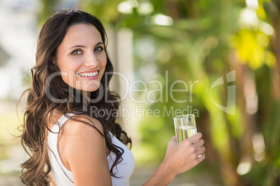 Pretty brunette drinking glass of water