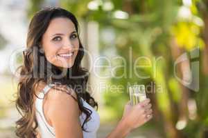 Pretty brunette drinking glass of water