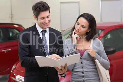 Salesman showing brochure to customer and smiling