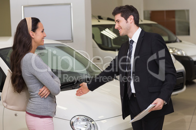 Businessman showing a car to a woman Businessman showing a car to a woman