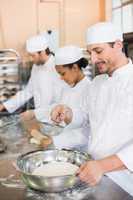 Team of bakers working at counter