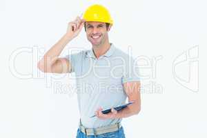Architect wearing hard hat while holding clip board