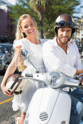 Attractive couple with their scooter