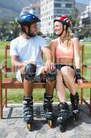 Fit couple getting ready to roller blade