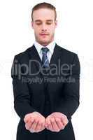 Concentrated businessman holding out his hands