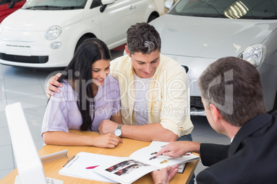 Salesperson pointing something on booklet
