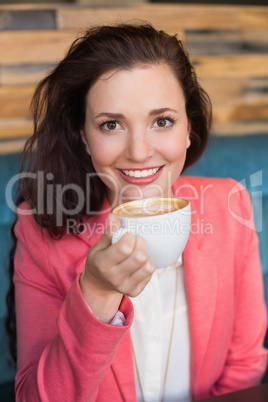 Pretty brunette having cup of coffee