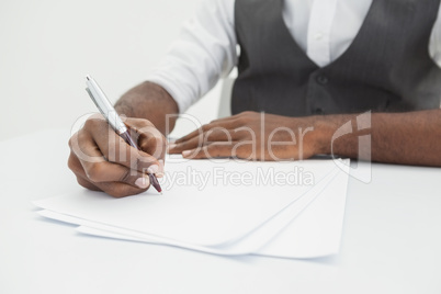 Businessman writing notes on paper