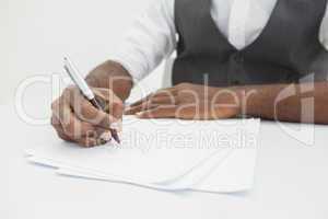 Businessman writing notes on paper