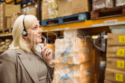 Warehouse manager giving orders on headset