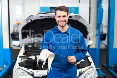 Mechanic testing oil in car