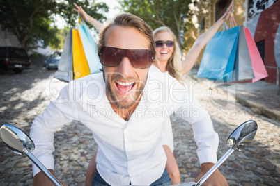 Attractive couple riding a scooter