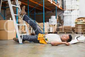 Worker lying on the floor in warehouse
