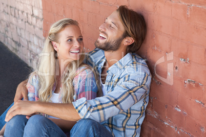 Cute couple sitting on ground