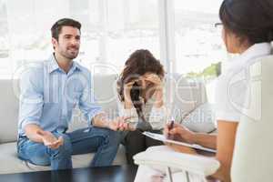 Couple fighting together in front of their therapist