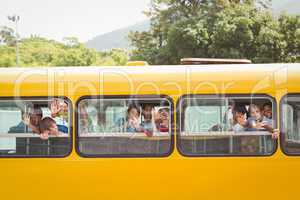 Cute pupils smiling at camera in the school bus