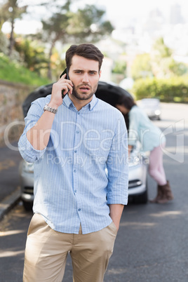 Young couple after a car breakdown