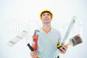 Worker holding various equipment over white background